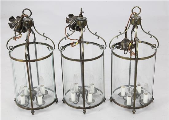 A set of three cylindrical brass mounted hall lanterns, 25in overall.